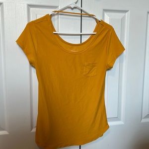 Short sleeved, yellow shirt.